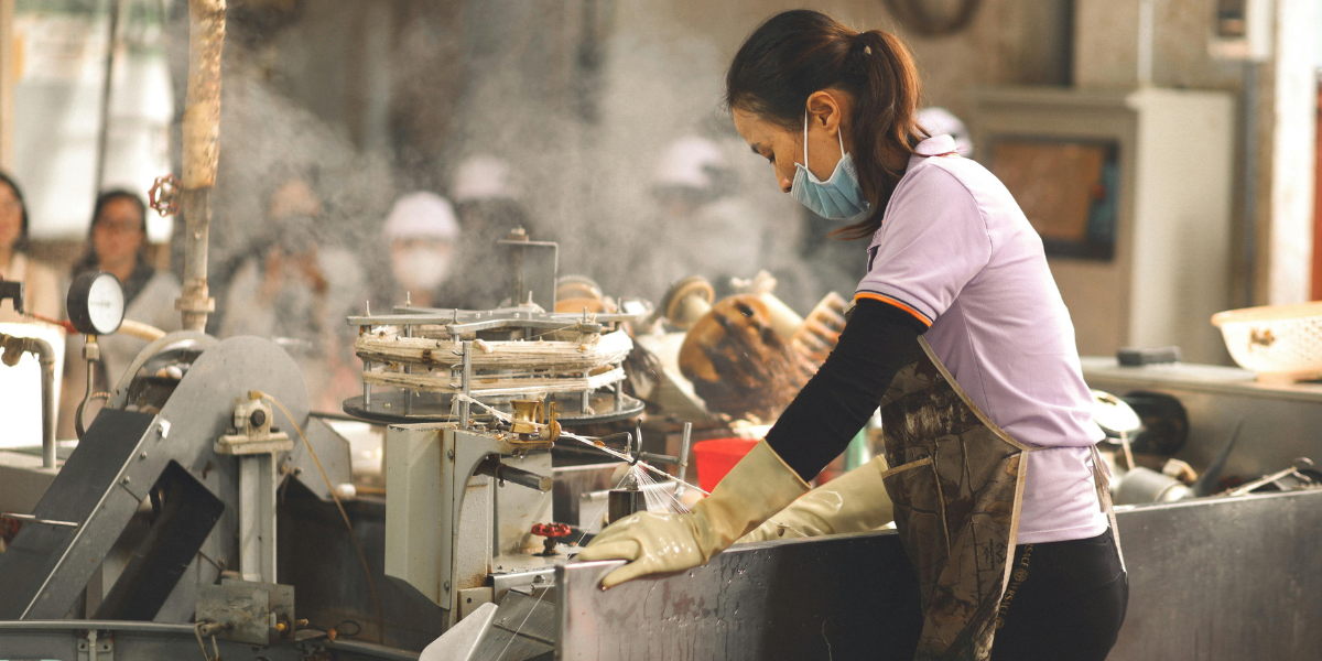 A female worker is processing Heavy duty webbing in a factory